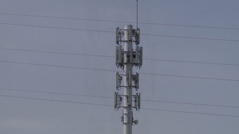 A cell tower with a lot of antennas on it.