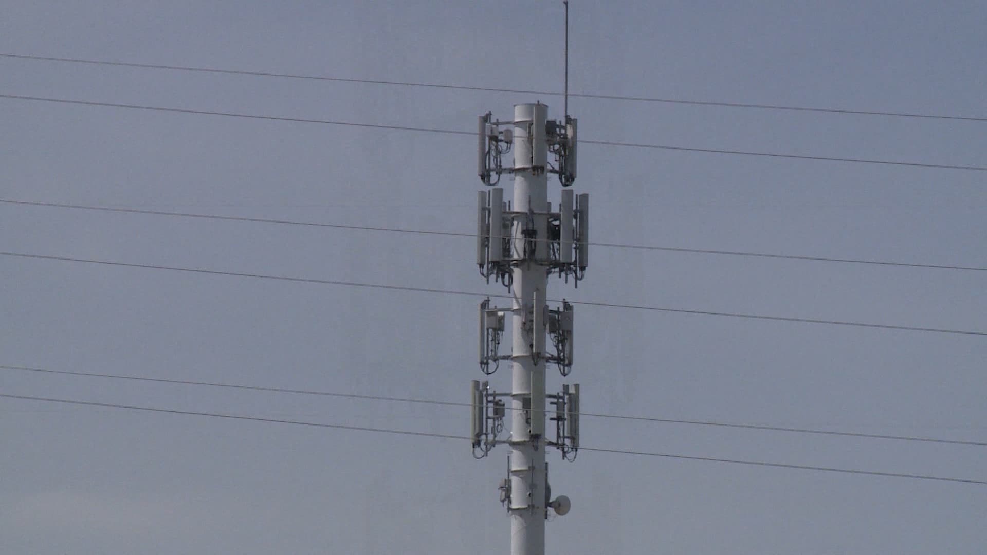 A cell tower with a lot of antennas on it.