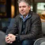 A man sitting on a couch in a hotel lobby.