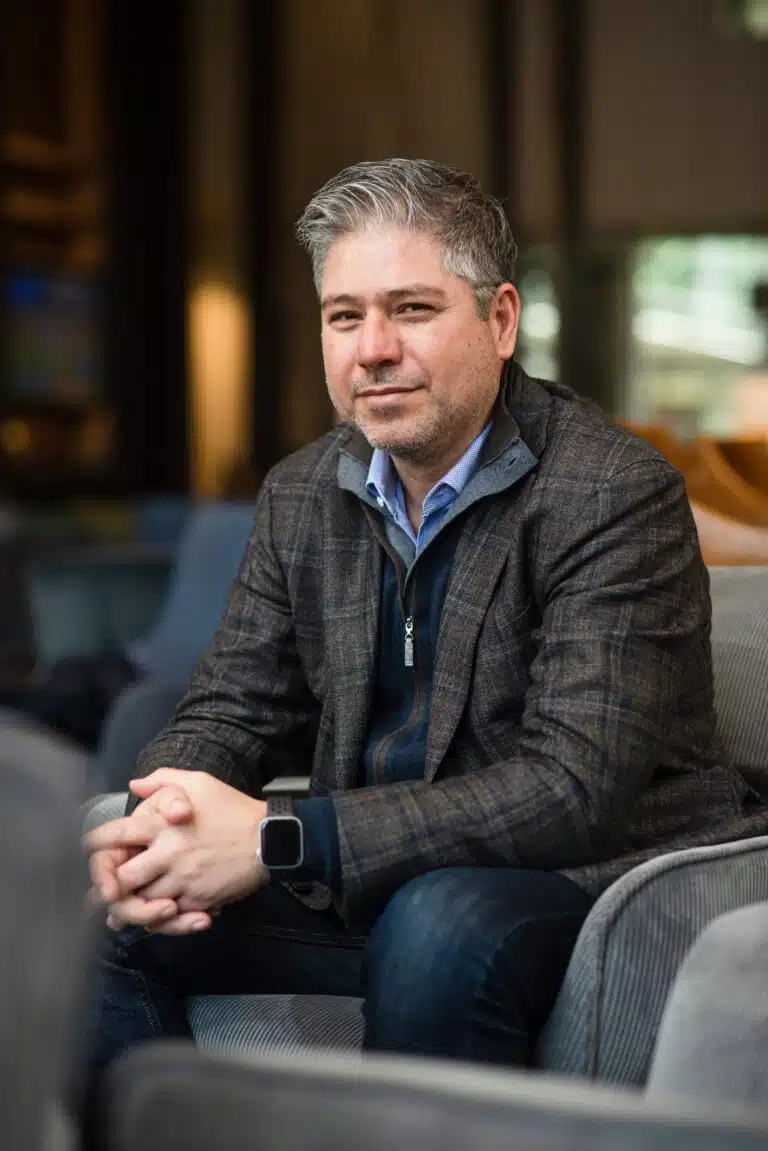 A man sitting on a couch in a hotel lobby.