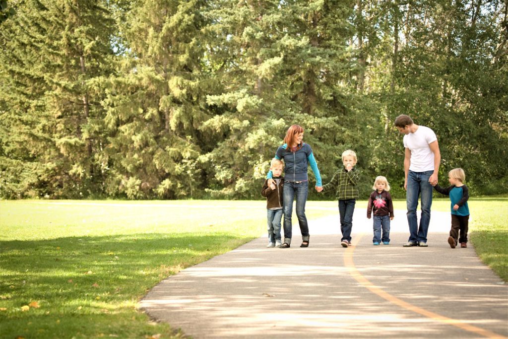A family walking down a path in a park.