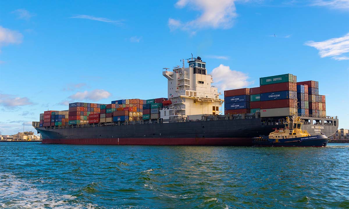 A large ship with containers on the water.