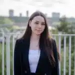 Christobelle Boily in a black blazer standing in front of a railing.