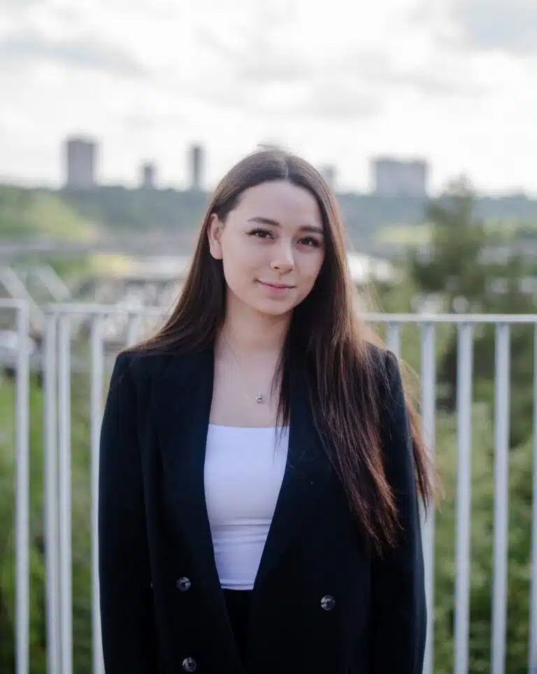 Christobelle Boily in a black blazer standing in front of a railing.